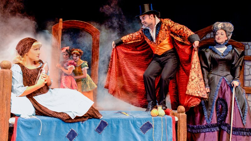 A mysterious man in a top hat and cape appears in Cinderellas room as she clutches her glass slipper