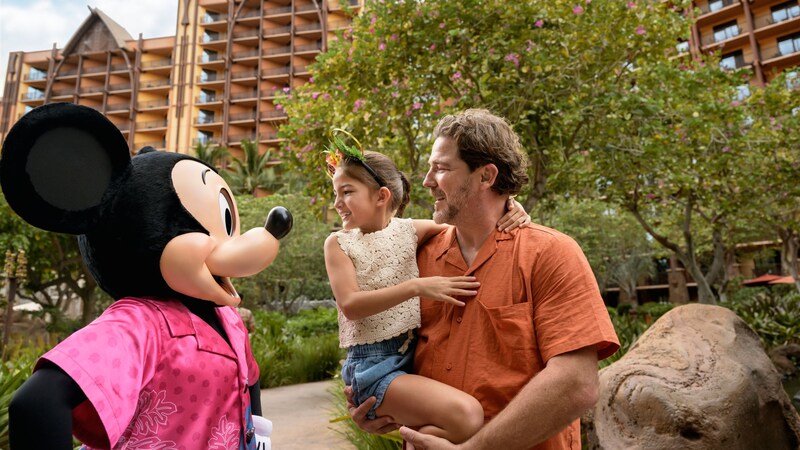 Mickey Mouse interacting with a parent and child at Aulani, A Disney Resort & Spa