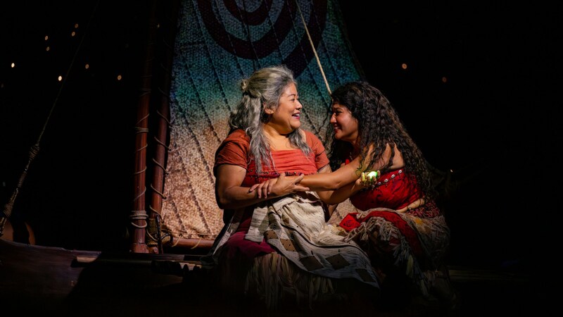 Moana sitting on her canoe with Gramma Tala during Disney The Tale of Moana, a stage show on board the Disney Treasure