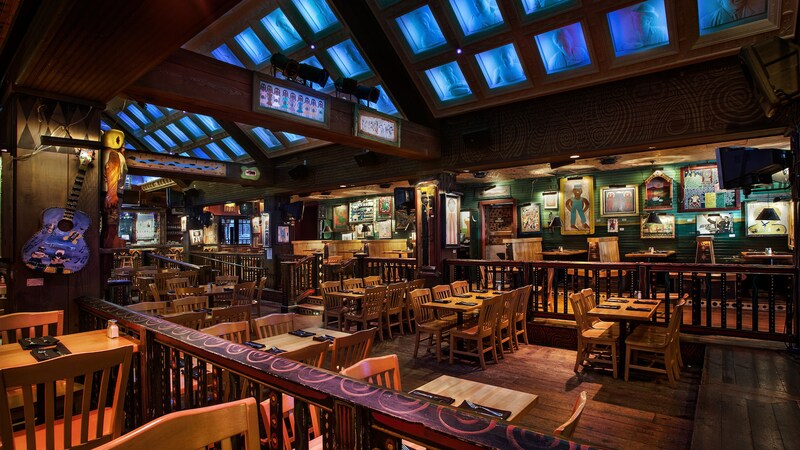 The House of Blues dining room features tables and chairs, a guitar and other music memorabilia on the walls as well as flat screen monitors on the ceiling