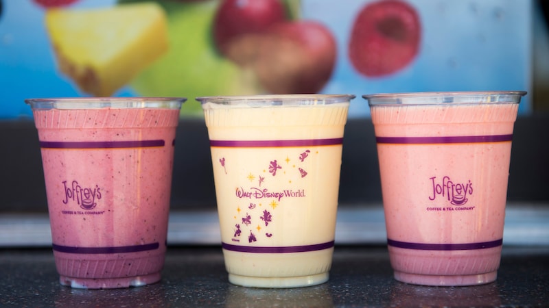 Three refreshing tropical smoothies in plastic cups