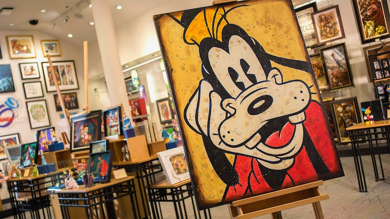 A piece of artwork featuring Goofy on display on an easel
