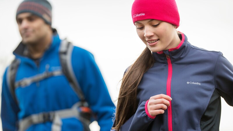A man and a woman dressed in cold weather hiking apparel by Columbia Sportswear