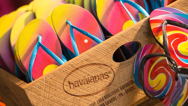 Stacks of vibrant flip flops on display inside a crate within the Havaianas shop at Disney Springs