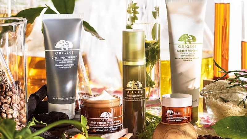 A display of Origins facial products among plant life