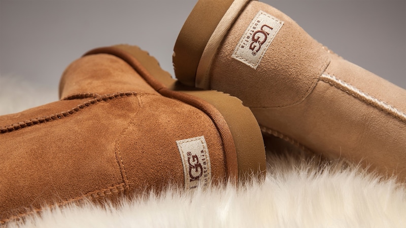 Two UGG boots rest upon a patch of sheepskin