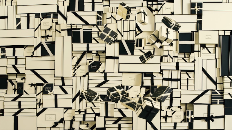 Graphic artwork featuring stacks of Jo Malone London signature boxes