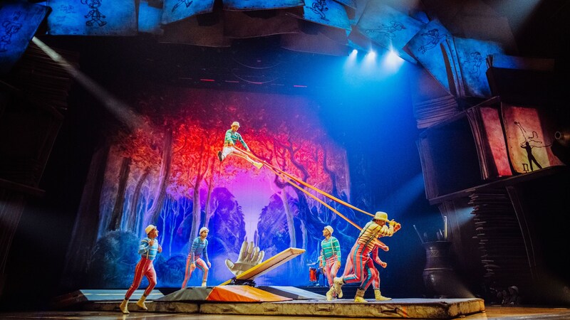 A circus act with performers using a springboard during Drawn to Life by Cirque du Soleil & Disney