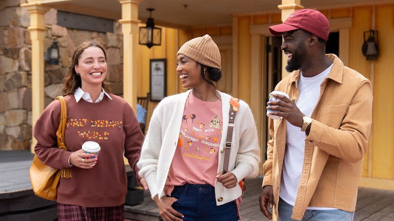 3 Guests wearing merchandise from the Disney Fall Collection