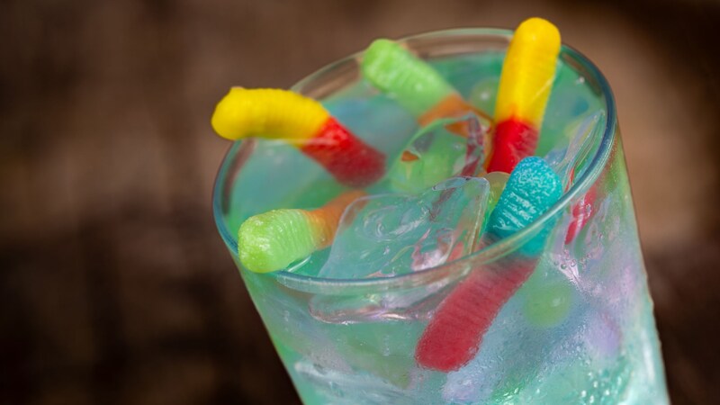 A drink served in a glass and topped with gummy worms