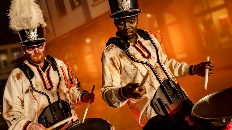 Two members of the Zombie Drummers percussion ensemble playing music at Disney Springs in Walt Disney World Resort