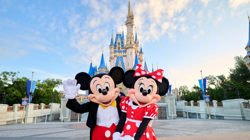 Mickey Mouse and Minnie Mouse posing in front of Cinderella Castle in Magic Kingdom park