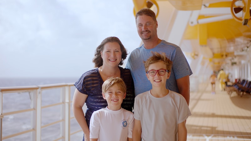 A mother, father and their 2 sons on the deck of a Disney cruise ship