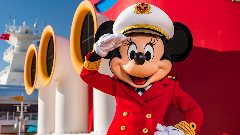 Captain Minnie Mouse offering a salute while standing on the deck of a Disney Cruise Line ship