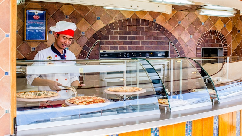 A walkup food station featuring pizza by the slice A walkup food station featuring pizza by the slice