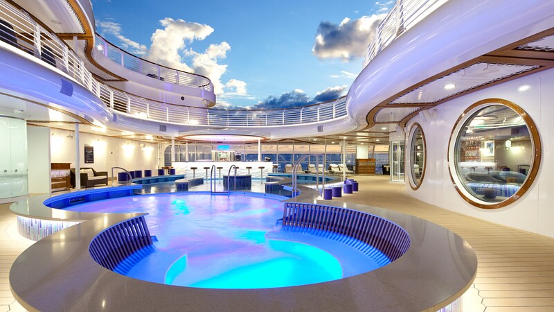 Upper decks surround an open area containing an interlocking circular pool, lounge chairs and walk up Cove Bar