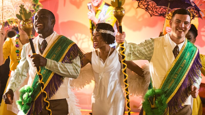 The Princess Tiana Character and other costumed performers with props engaged in a New Orleans style celebration