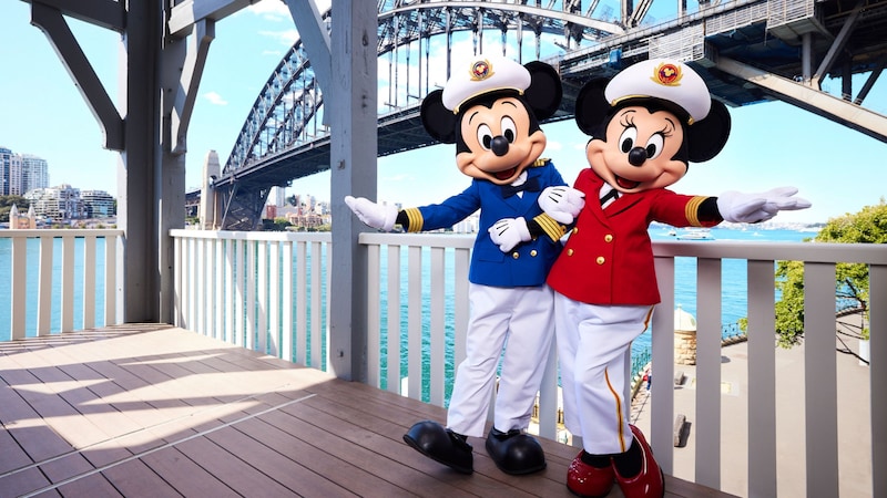Captains Mickey Mouse and Minnie Mouse posing next to the iconic Sydney Bridge