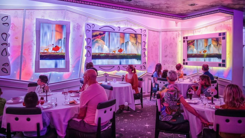 The interior of Animator’s Palate reveals families dining at tables while watching an animated show in progress