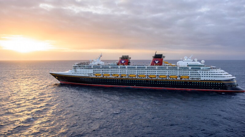 The Disney Wonder cruise ship sailing the open waters at sunset