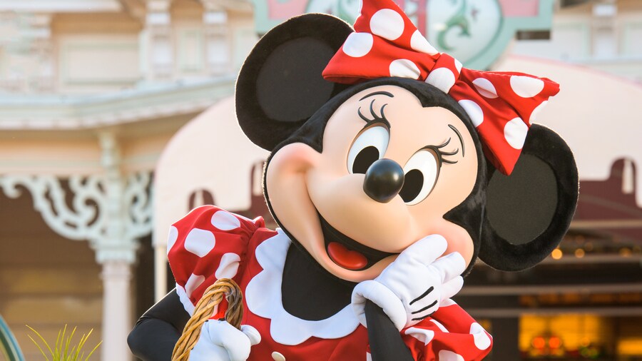 Minnie Mouse carries a basket and strikes a cute pose