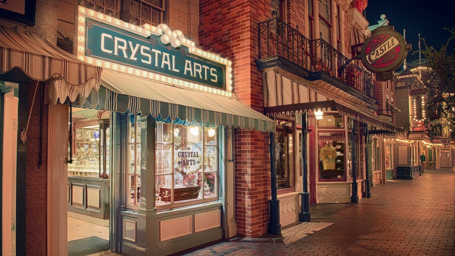 Fine crystal glassware sparkles in the evening while lining the window displays at Crystal Arts