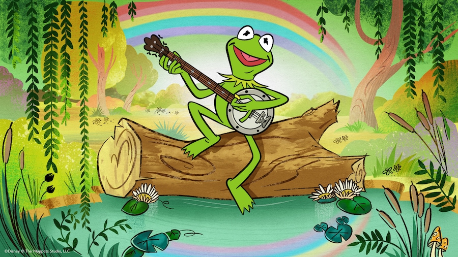 An illustration of Kermit the Frog playing a banjo while sitting on a log surrounded by lily pads and flowers, with a rainbow in the background