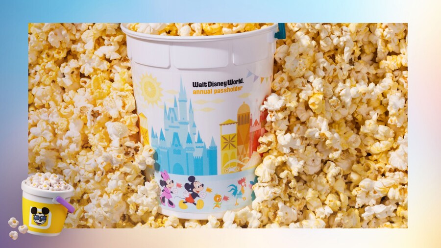 A Walt Disney World Annual Passholder popcorn bucket laying in a bed of popcorn