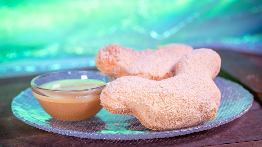 A plate of Butterscotch Beignets with sauce from Mint Julep Bar, available during Disneyland After Dark: Pride Nite