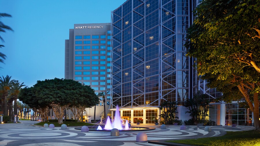 Hyatt Regency hotel exterior near a fountain courtyard at dusk