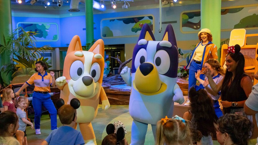Bingo, Bluey and Disney Cast Members dancing with a group of kids