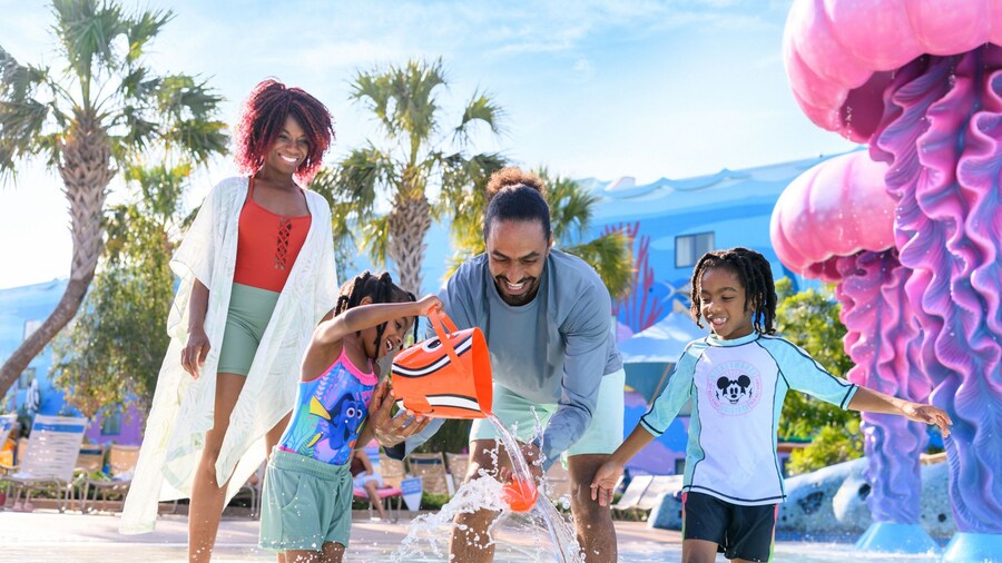 A family of 4 Guests playing in the Big Blue Pool at Disney’s Art of Animation Resort