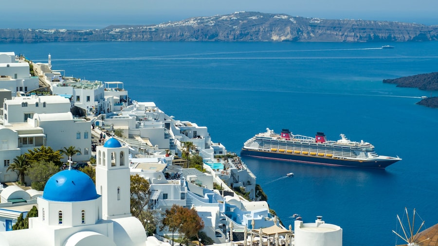 A Disney cruise ship entering the harbor of a Greek island