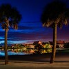Nighttime view of Disney's Polynesian Resort seen from a nearby beach