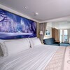 A stateroom featuring Frozen artwork over the bed and a connecting verandah