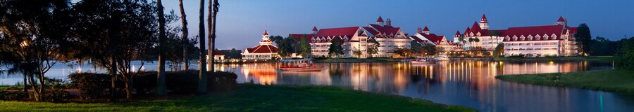 Disney's Grand Floridian Resort & Spa, a stately Victorian beach resort, on the shore of a lake lined with palm trees