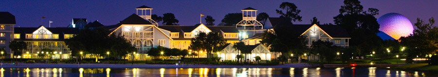 A night view of Disney's Beach Club Resort on the shore of Crescent Lake