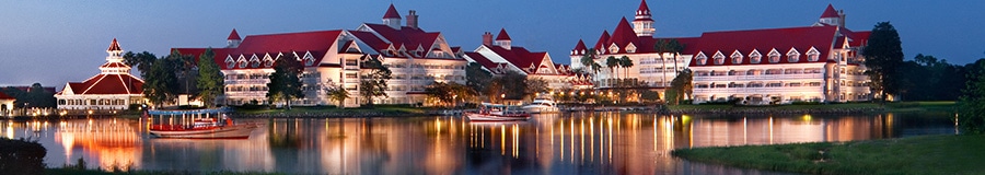 A view of Disney’s Grand Floridian Resort & Spa from across Seven Seas Lagoon at dusk