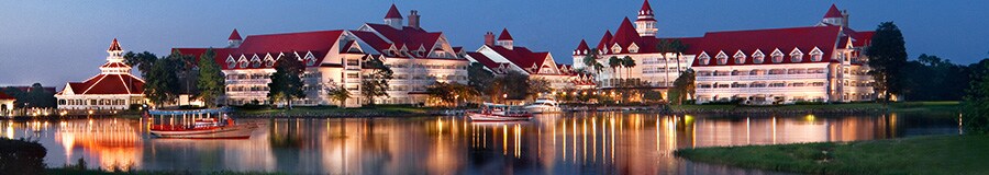 A view of Disney’s Grand Floridian Resort & Spa from across Seven Seas Lagoon at dusk