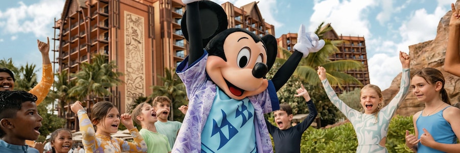 Mickey Mouse dancing with a group of children next to one of the pools at Aulani, A Disney Resort & Spa