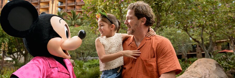 Mickey Mouse interacting with a parent and child at Aulani, A Disney Resort & Spa