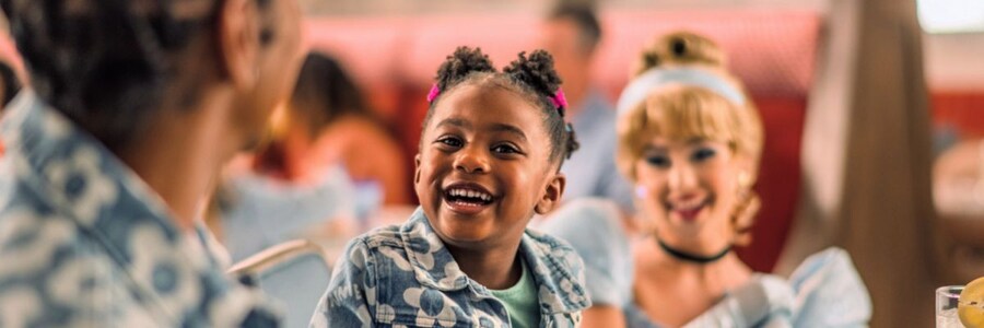 A girl smiles near Cinderella
