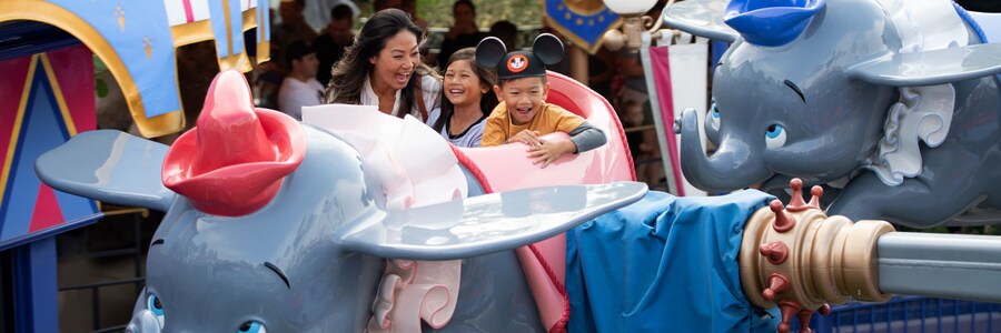 Mom and kids riding Dumbo in Disneyland