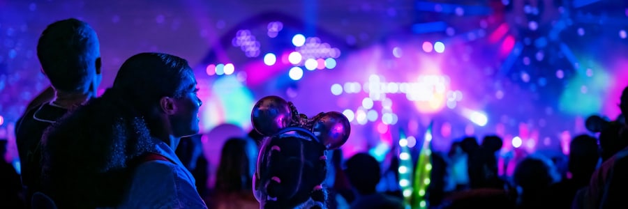 Guests taking in dazzling lights and projections during the night at the Disneyland Resort.