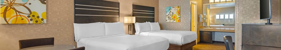 A Best Western Plus Park Place Inn & Mini Suites Standard Double room with 2 beds, a dinette set, a bathroom, a sink, a TV and a desk 