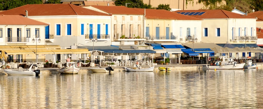 A harbor filled with small fishing boats and lined with sidewalk cafes A harbor filled with small fishing boats and lined with sidewalk cafes