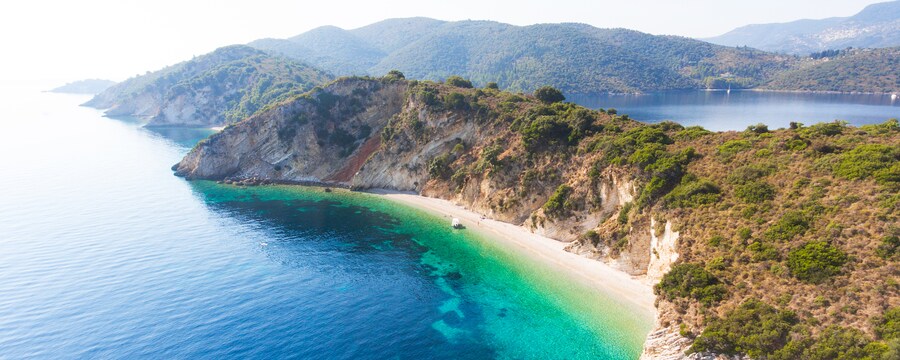 A verdant coastline with steep cliffs and tranquil waters