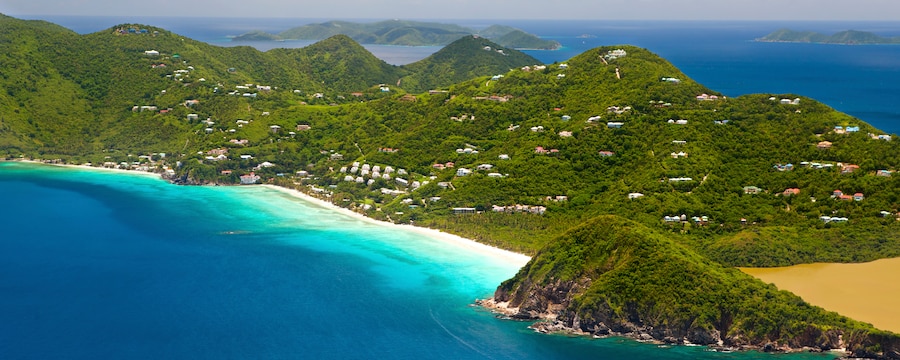 A tropical island features rolling hills blanketed with trees A tropical island features rolling hills blanketed with trees