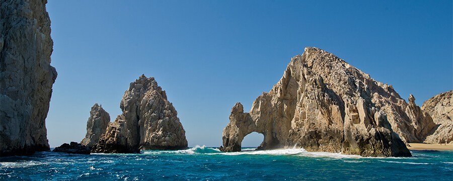 Two mountain shaped rock formations stand above the waves