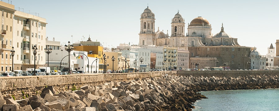 Concrete blocks fortify the shoreline next to old buildings in Cadiz Spain Concrete blocks fortify the shoreline next to old buildings in Cadiz Spain